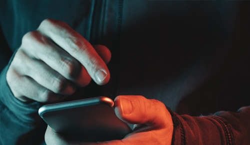 finger touching phone screen