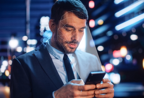 man holding phone scanning face