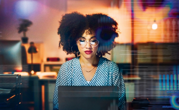 woman with glasses at computer looking at computer screen