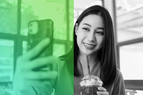 image of young female holding phone. Woman holding drink.
