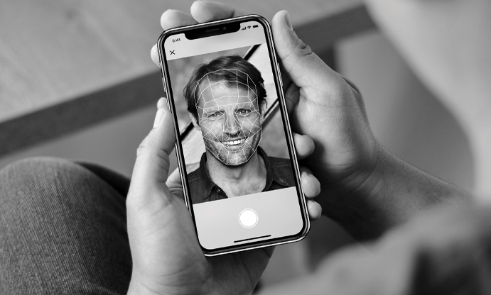 image of phone screen showing a male's selfie with biometrics lines on face.