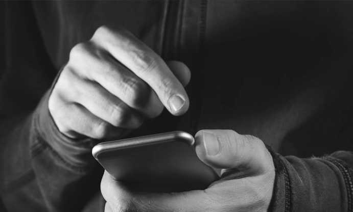 image of male holding phone