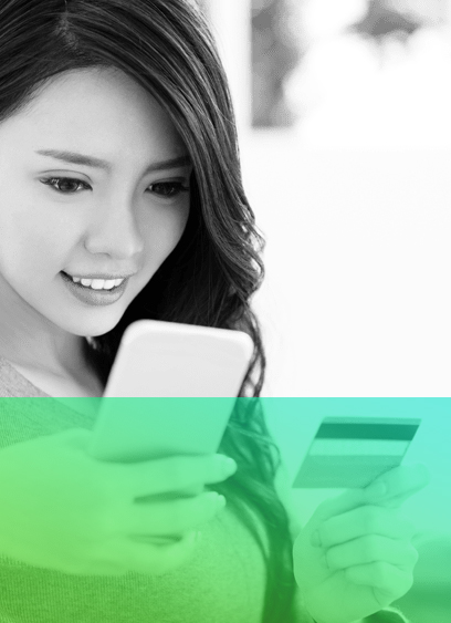 green gradient image with woman in background smiling at photo and holding a credit card in hand.