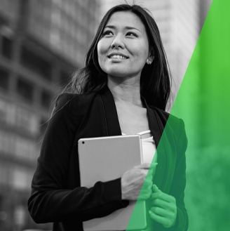 image of woman holding laptop in hand smiling.