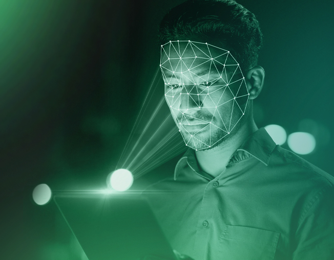 image of male looking at screen with biometric lines portraying on face.