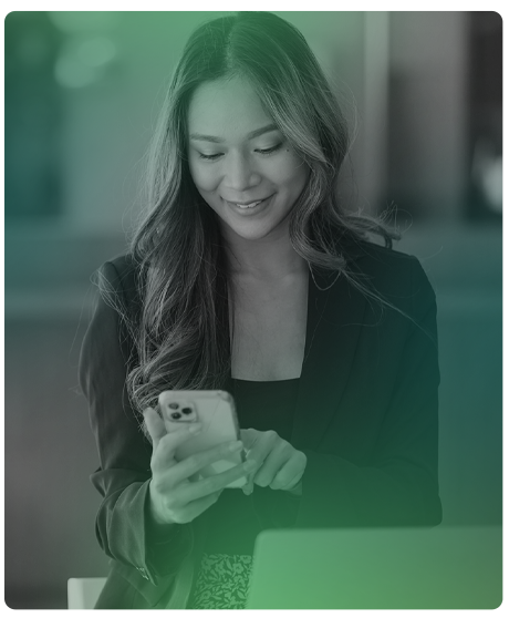 image of woman holding phone in her hand smiling.