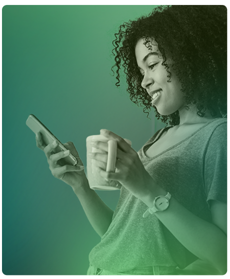 image of woman holding her phone and a coffee mug