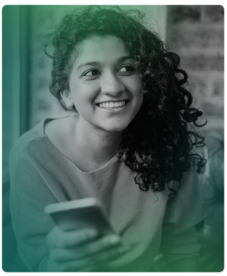 image of female sitting smile. Female is on her phone