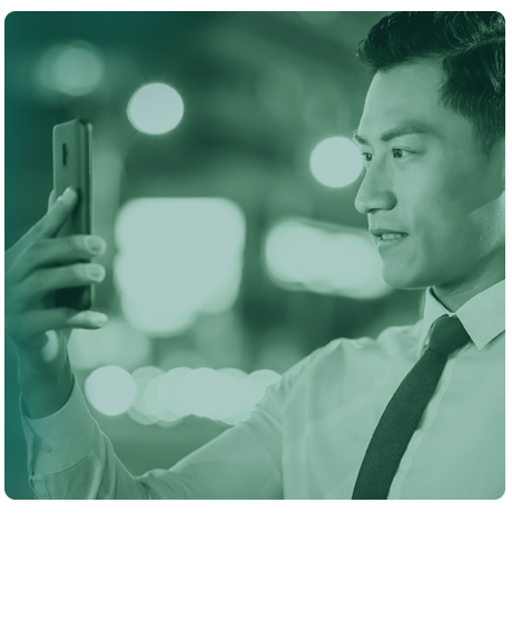 image of male holding smart phone up to his face.